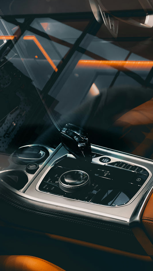a car dashboard with a steering wheel and dashboard controls