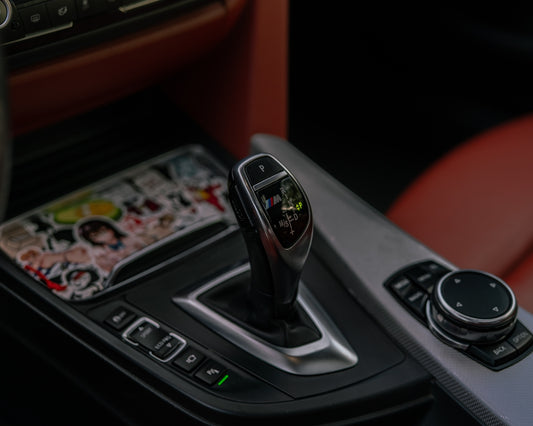 Close-up of a car's automatic gear shifter and console.